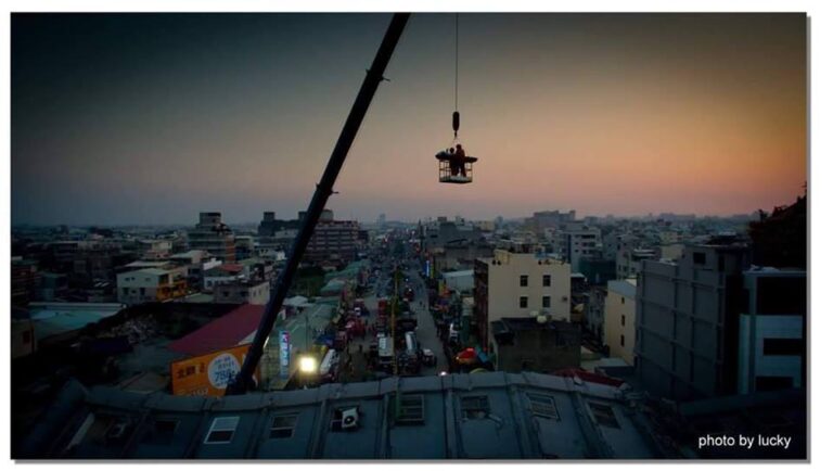 A crane lifts the body of a victim of Taiwan's earthquake February 7, 2016